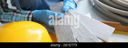 Builder holding gray tiles for bathroom in workshop closeup Stock Photo