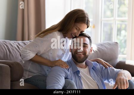 Happy young beautiful woman and handsome man relaxing at home Stock Photo