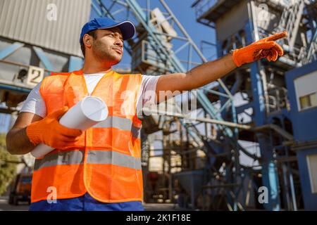 African male engineer inspecting site at construction plant Stock Photo