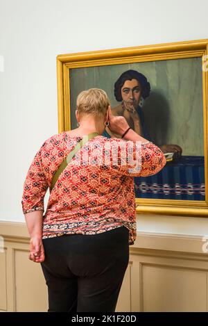 Visitor in front of Swiss artist Felix Vallotton's painting 'Return from the Sea', early 20th century, Art and history museum, the largest museum in the city, Geneva, Switzerland Stock Photo