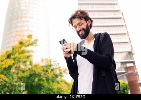 stylish young man using a mobile phone in the city Stock Photo