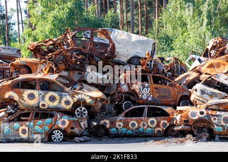 A pile of mangled burned cars near the city of Irpin near Kyiv after the expulsion of Russian occupiers. 08.30.2022. Irpin. Ukraine. Stock Photo