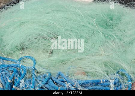 fine-meshed fishing nets for small fish or crabs lying in a heap after use and before cleaning Stock Photo