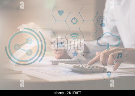 Close-up of economist using calculator while going through bills and taxes in the office. Stock Photo