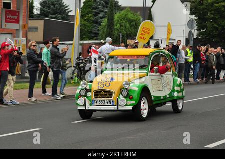 A cute green and yellow Citroen 2CV at the 2017 Tour de France in Meerbusch, Germany with spectators around it Stock Photo