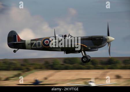 Supermarine Spitfire Mk.IXb MH434 (G-ASJV) landing at dusk, after it's flying display at the IWM Duxford Battle of Britain Airshow 10th September 2022 Stock Photo