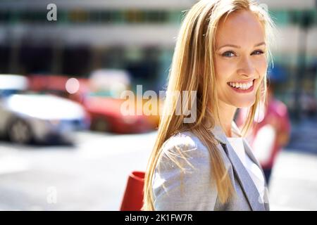 City smiles. A portrait of a beautiful young woman in the city. Stock Photo
