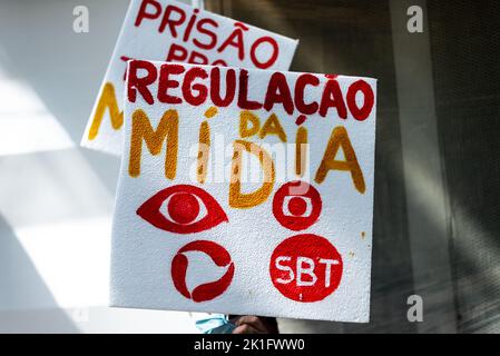 Brazilians protest carrying posters against the government of President Jair Bolsonaro in the city of Sal Stock Photo