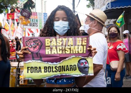 Brazilians protest carrying posters against the government of President Jair Bolsonaro in the city of Sal Stock Photo