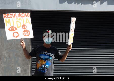 Brazilians protest carrying posters against the government of President Jair Bolsonaro in the city of Sal Stock Photo