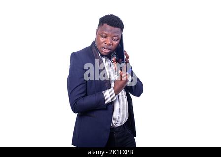 young forgetful businessman wearing a suit and talking on a digital tablet. Stock Photo
