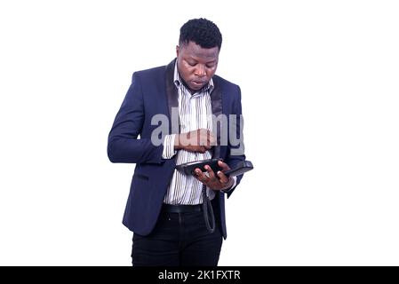young serious businessman wearing suit dialing number on cellphone. Stock Photo