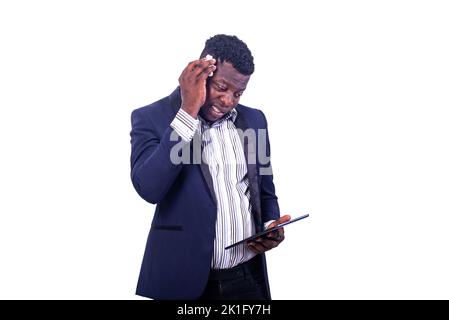 young businessman suffering from heat, wiping sweat from his forehead with a handkerchief while working on a digital tablet. Stock Photo