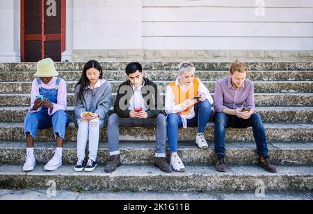 Friends group of millennial people using mobile smart phone together Stock Photo