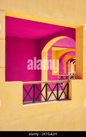 Pink and yellow painted building facade, selective focus, architecture background. Stock Photo