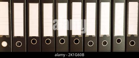Black office folders standing on cabinet shelves Stock Photo