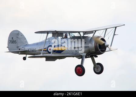 K7985, Gloster Gladiator Mk1 landing at dusk, after it's pleasure flight at the IWM Duxford Battle of Britain Airshow 10th September 2022 Stock Photo