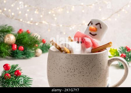 Mug with hot chocolate with melted marshmallow snowman Stock Photo