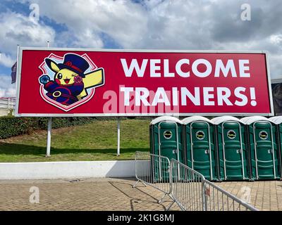 London, United Kingdom - September 11 2022: A billboard with an inscription Welcome trainers and a picture of Pikachu in front of ExCeL London. Stock Photo