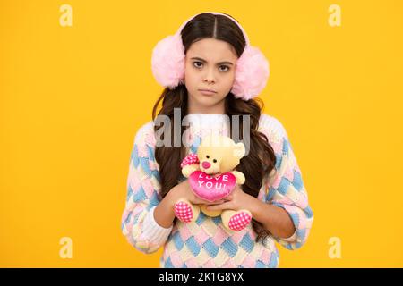 Cheerful teen child hold toy. Happy childhood. Kid playing toy. Childcare concept. Angry teenager girl, upset and unhappy negative emotion. Stock Photo