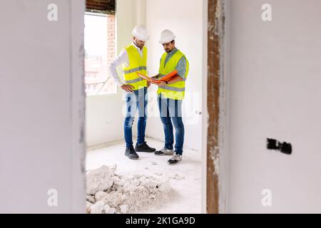 Two young architects male working together at construction site Stock Photo