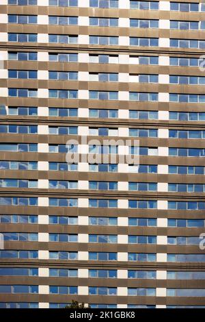 Multi-storey house in blue color with white window frames and many small windows Stock Photo