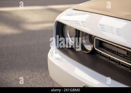 Close-up of a white car on the gray road Stock Photo