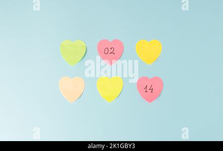 Valentine's Day post it notes reminder on a pale blue background. Minimal concept. Stock Photo