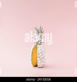 Fresh pineapple colored in white with one cut slice. Minimal summer food concept idea. Stock Photo