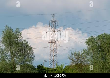 Transmission line pylon close up against big cumulonimbus cloud, transmission line Stock Photo