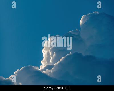 Building Cumulonimbus clouds against blue sky Stock Photo