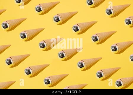 Summer pattern with ice cream cones and disco balls on yellow background. Minimal concept. Stock Photo