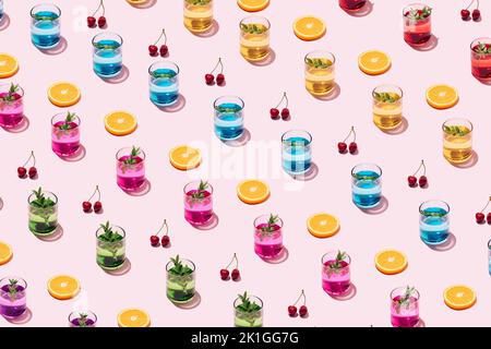 Summer cocktail pattern with drinking glasses, slices of orange and cherries on pink background. Stock Photo
