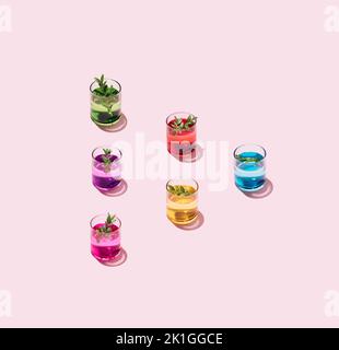 Six cocktail glasses arranged in triangle or play button on pink background. Minimal concept. Stock Photo