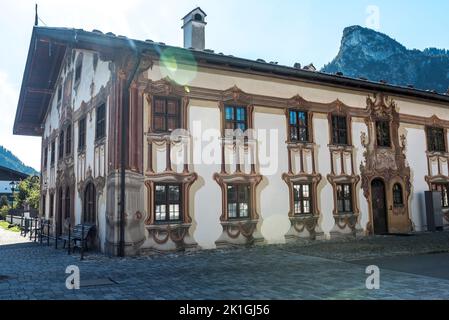 Oberammergau, Germany - October 2021: Facade with a religious mural painted on the streets of the Bavarian town of Oberammergau. Stock Photo