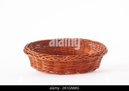 Profile view of vintage weave wicker basket with shallow depth of field on front. Isolated on white background. Stock Photo