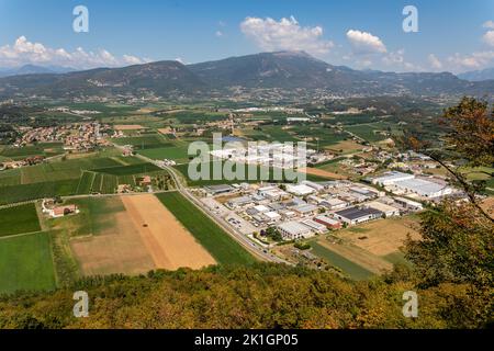 Business parks, villages Albarè Stazione and Gazzoli and vineyards in an areal view from Monte Moscal in the village of Affi, Verona in Italy. Stock Photo
