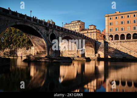 The smooth river Tiber under the Ponte Sisto bridge in Rome, Italy. Stock Photo