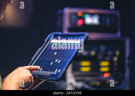 Remote control and sound settings from the tablet. Stock Photo