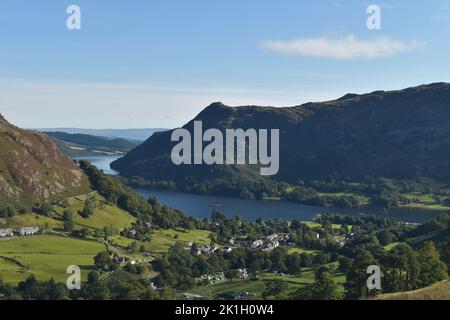 View over Glenridding and Ullswater, Lake District, UK, towards Birk Fell and Bleaberry Knott rising to Place Fell on a clear, dry early autumn day. Stock Photo