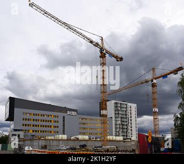 two cranes at the construction site of residential buildings Stock Photo