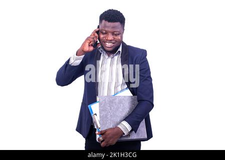 young businessman wearing elegant suit holding document and talking on mobile phone while smiling. Stock Photo