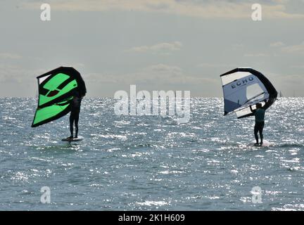 Windsurfing Water Sport - Surfers Completing The Sport On Hayling Island Beachfront Stock Photo