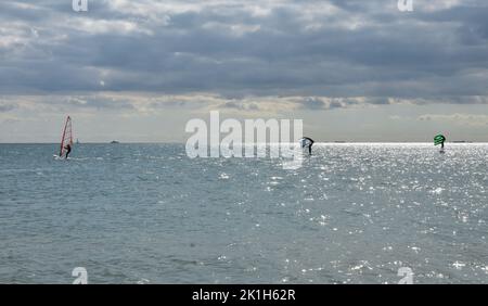 Windsurfing Water Sport - Surfers Completing The Sport On Hayling Island Beachfront Stock Photo