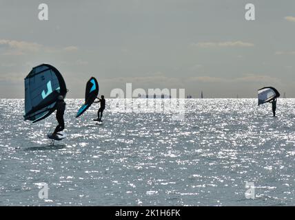 Windsurfing Water Sport - Surfers Completing The Sport On Hayling Island Beachfront Stock Photo