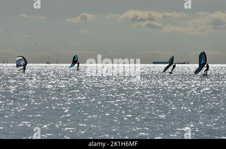 Windsurfing Water Sport - Surfers Completing The Sport On Hayling Island Beachfront Stock Photo