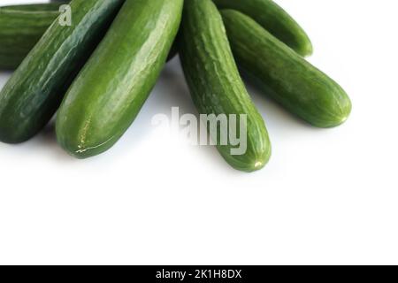 Isolated Heap of green Cucumbers, group of fresh cucumbers on the white background. Close-up, top view, macro, copy space Stock Photo