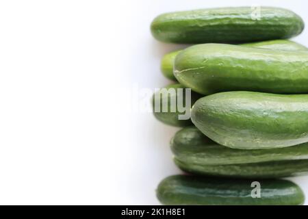 Isolated Heap of green Cucumbers, group of fresh cucumbers on the white background. Close-up, top view, macro, copy space Stock Photo