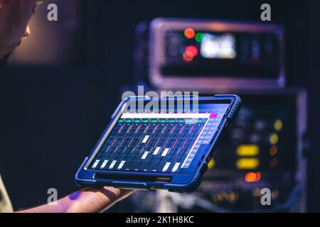 Remote control and sound settings from the tablet. Stock Photo