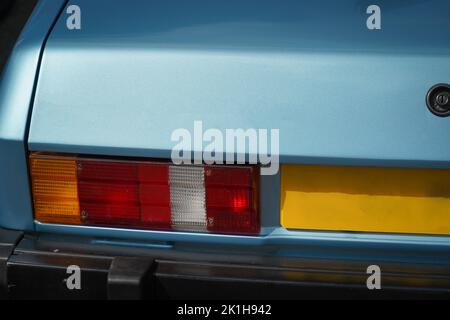 Close up of the rear light (taillight) of a classic blue car from 1980s Stock Photo